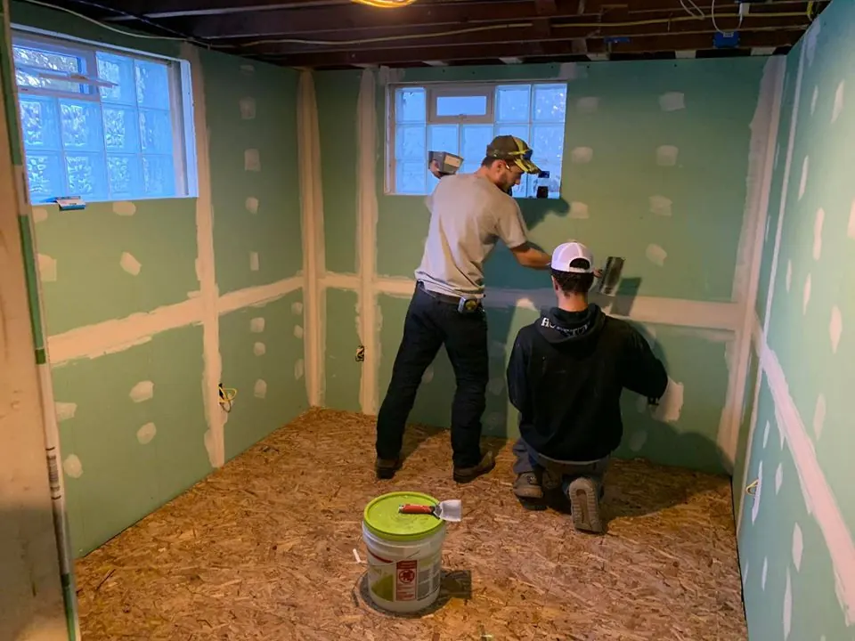 Crew installing drywall in a basement room by Monthly Upkeep in the Cleveland area